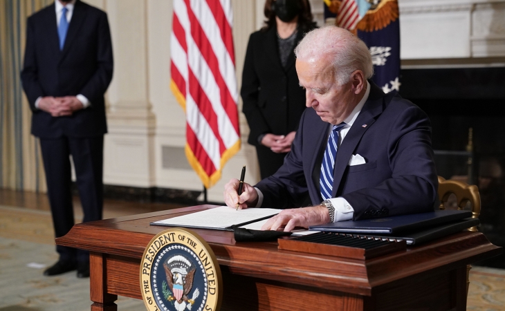 President Joe Biden signing a document